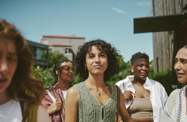 young woman standing with friends after a yoga class at a wellness retreat